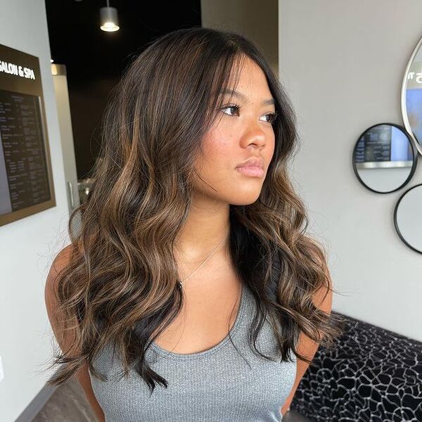 a woman wearing a gray sleeveless shirt