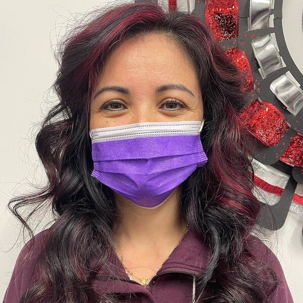 a woman wearing a purple facemask