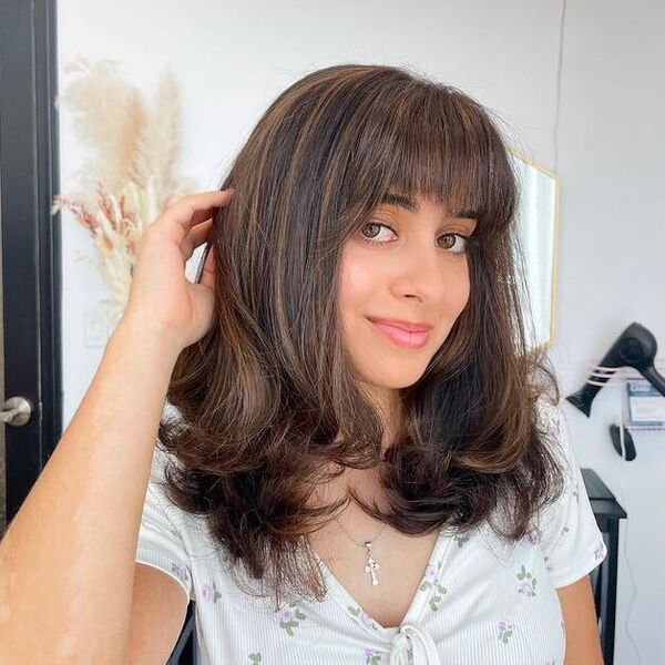 a woman wearing a white printed top