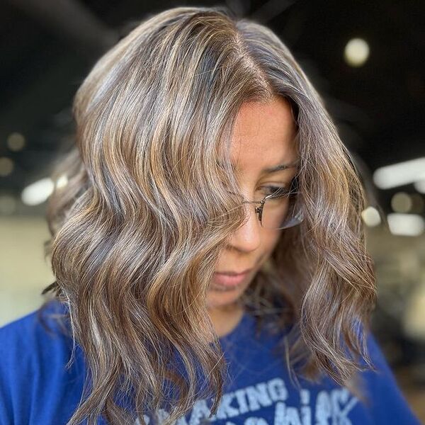 a woman with eyeglasses wearing a blue shirt