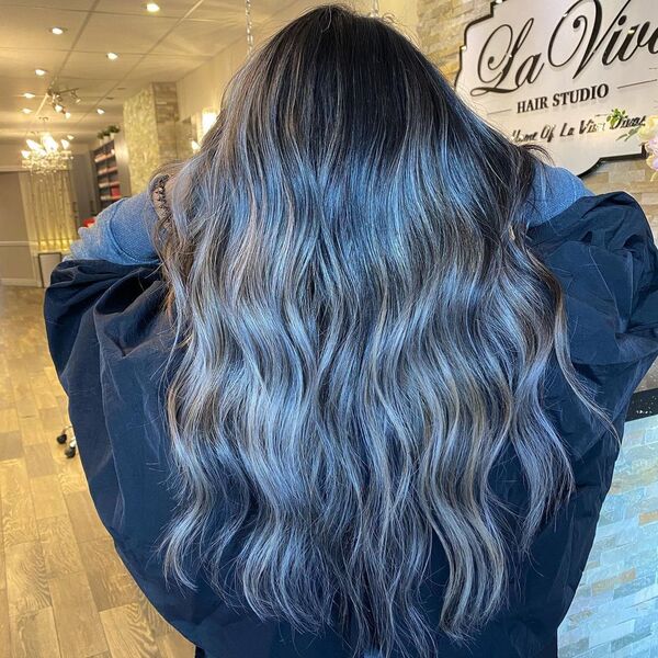 Ash Brown Blended Balayage - a woman in a hair studio holding her hair