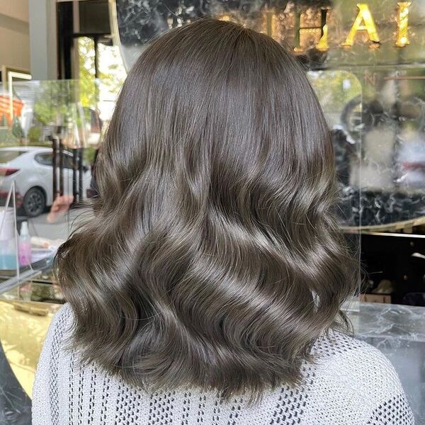 Beach Wave Silver Ash Brown - a woman in a salon wearing a crochet top