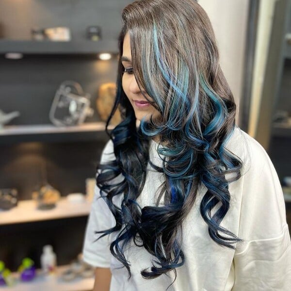 Black Blue Hair with Curly Ends - a woman wearing a white shirt