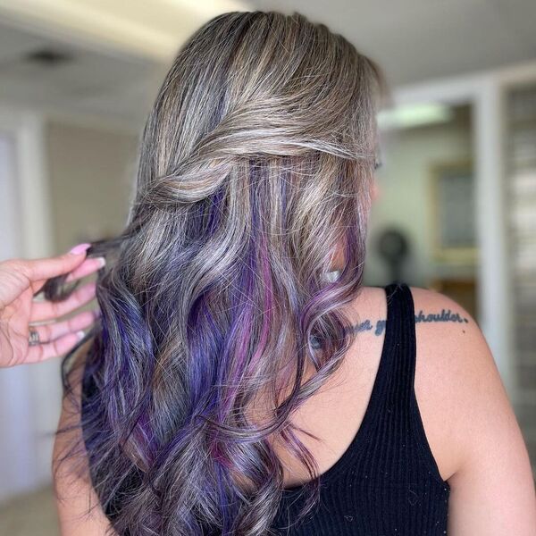 Blonde Balayage with Pink and Purple Streaks - a woman wearing a sleeveless top and has tattoo on her back shoulder