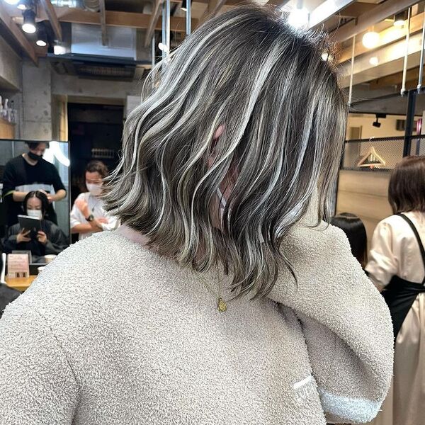 Blonde Gray Hair Balayage - a woman wearing a thick jacket