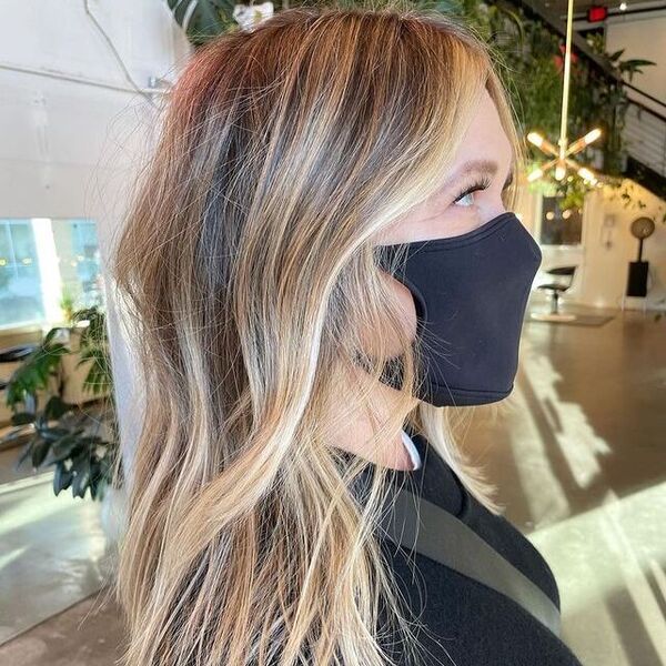 blonde highlights - a woman wearing a black facemask