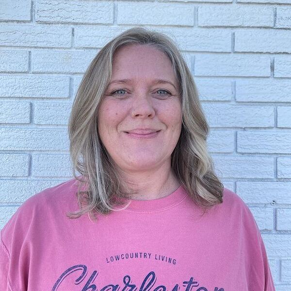 blonde highlights - a woman wearing a pink shirt