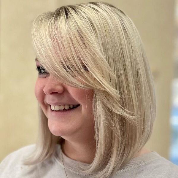 Bob Hair Summer Blonde - a woman smiling and is wearing a gray shirt