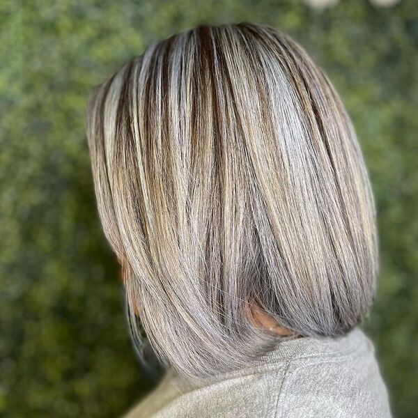 Bob Hair with Platinum Highlights - a woman wearing a gray shirt and in a grass type background