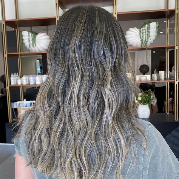 Bright and Dimensional Blonde Balayage - a woman wearing a faded olive gray shirt