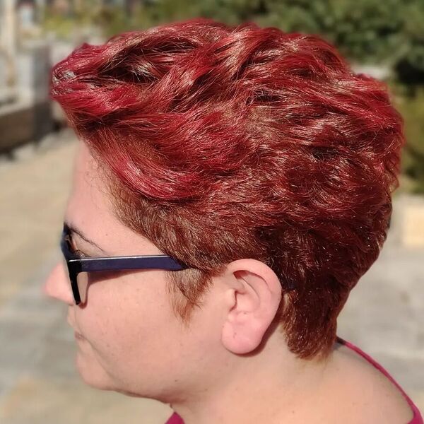 Bright Textured Red Brown Pixie -a woman wearing glasses.