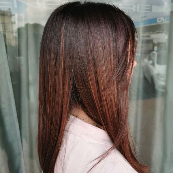 Brown Copper hair with Side Bangs - a woman wearing baby pink shirt.