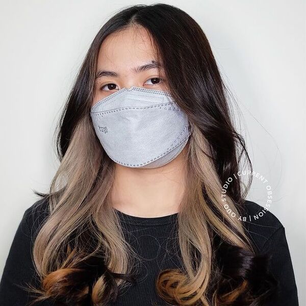 brown peekaboo hair - a girl wearing black shirt and gray mask