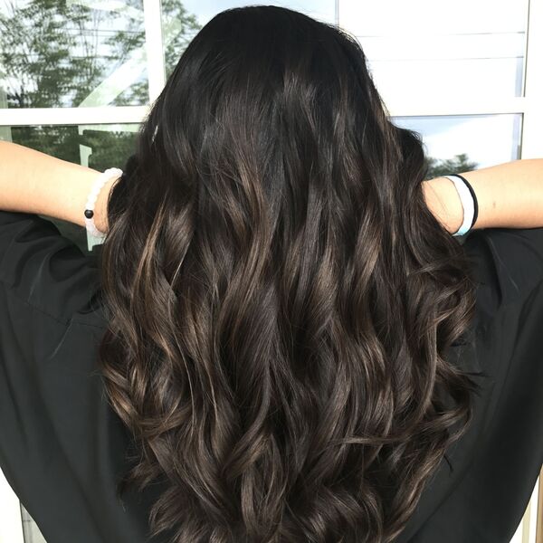 brown peekaboo hair - a girl wearing black shirt lifting her hair
