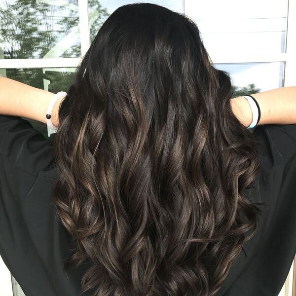 brown peekaboo hair - a girl wearing black shirt lifting her hair