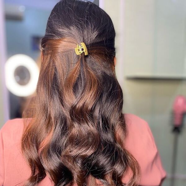 brown peekaboo hair - a girl wearing pink shirt and has a yellow hair clipper on her hair