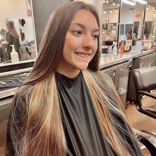 brown peekaboo hair - a woman wearing black barbers cape