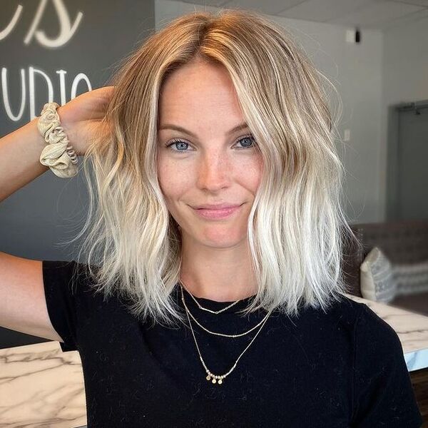 Brown to White Blonde Ombre Hair - a woman wearing a black shirt