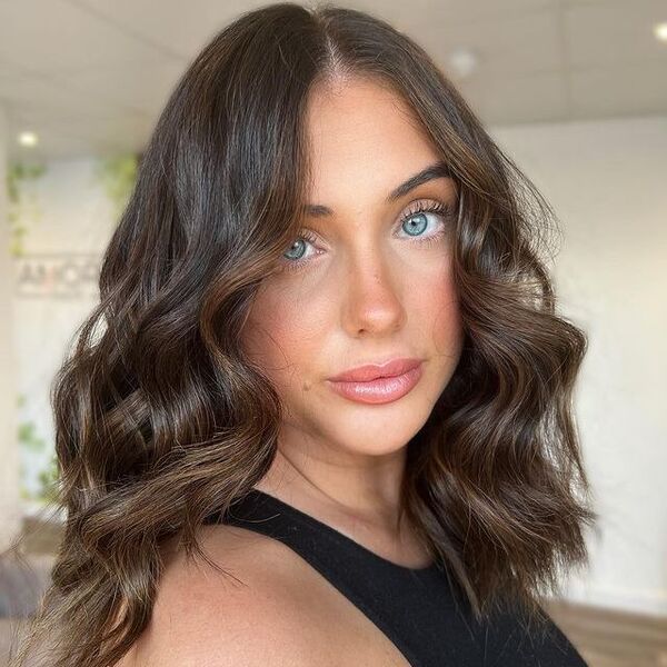 brunette - a woman wearing a black sleeveless shirt