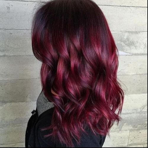 burgundy balayage on wavy hair 