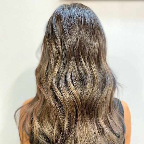 Cool Ash Brown Hair - a woman wearing a black sleeveless