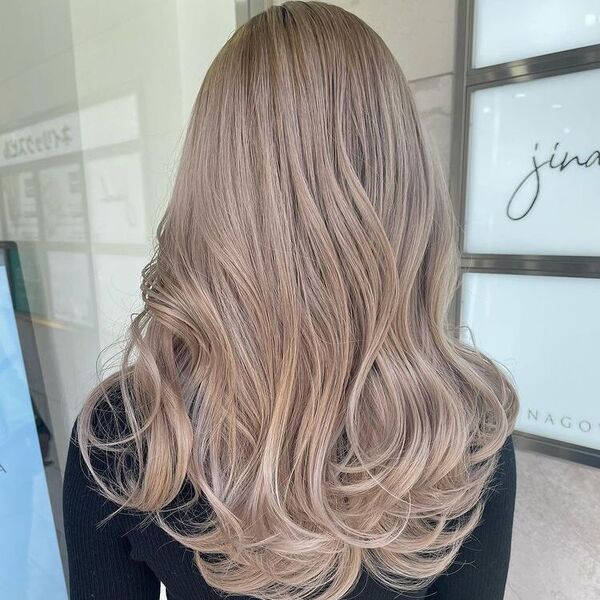 Creamy Brown Ash Hair - a woman wearing a black knitted long sleeve