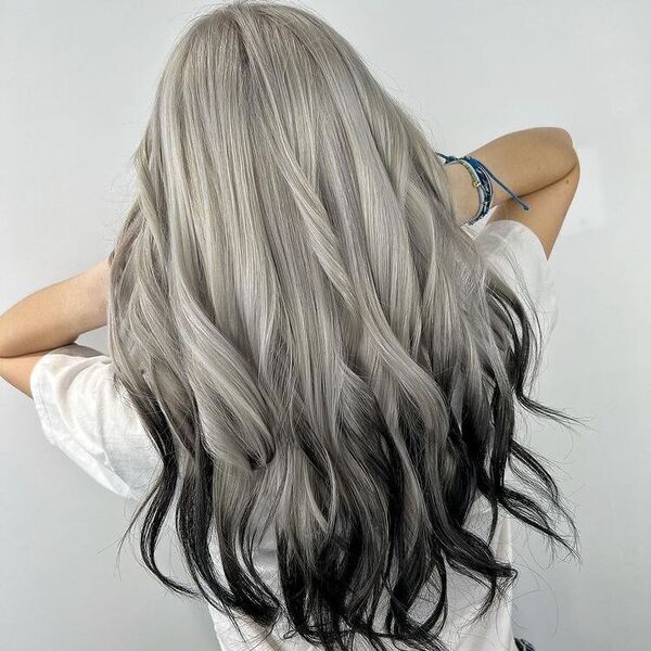 Creative Color Melt on Long Hair - a woman wearing a white shirt and has bracelets