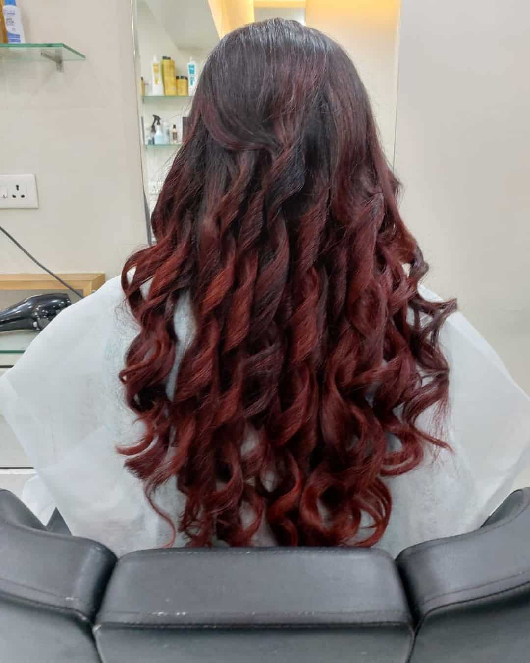 Curled Up Red Highlights On Black Hair Formal Look