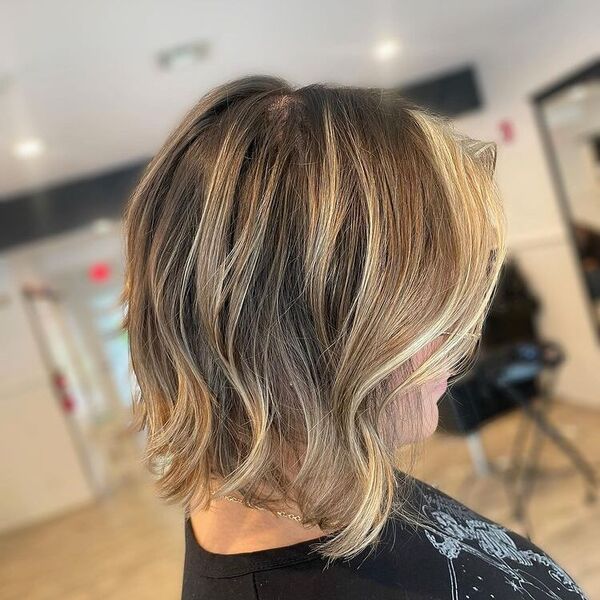 dark blonde hair - a woman wearing a black printed shirt