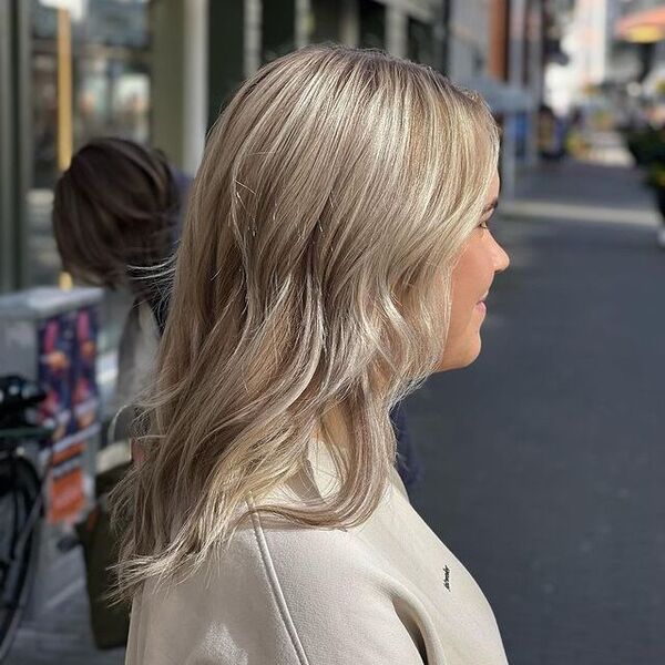 dark blonde hair - a woman wearing a brown longsleeve