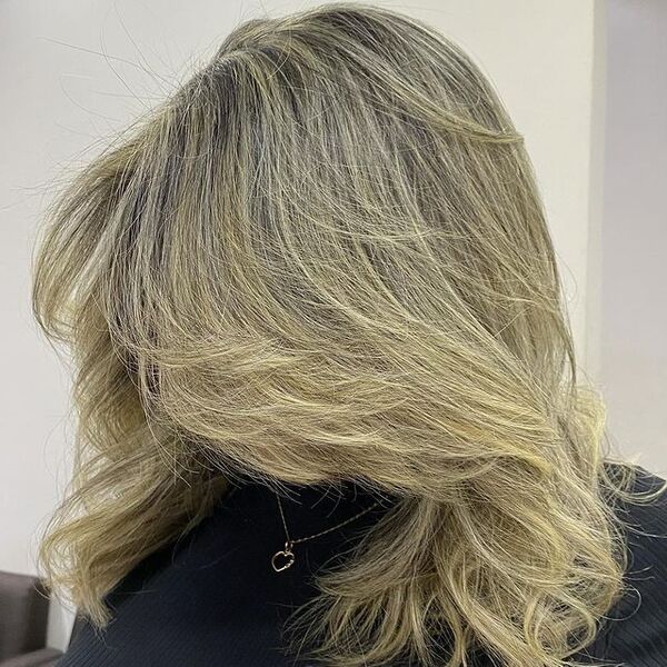 dark blonde hair - a woman wearing a heart necklace