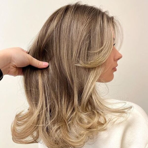 dark blonde hair - a woman wearing a white longsleeve