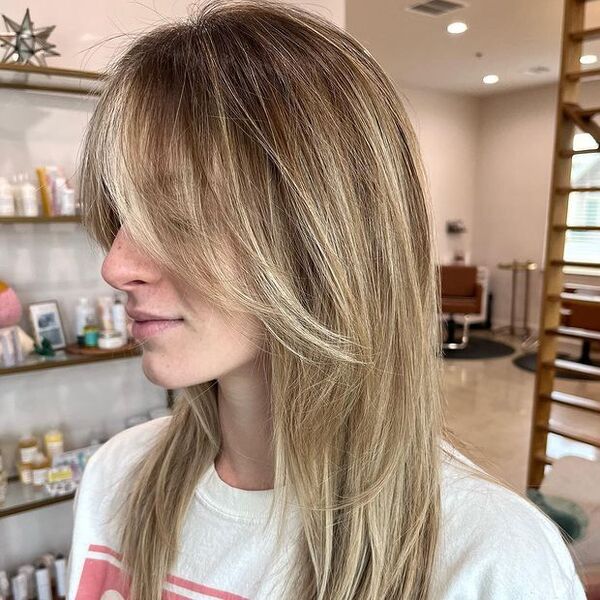 dark blonde hair - a woman wearing a white printed shirt