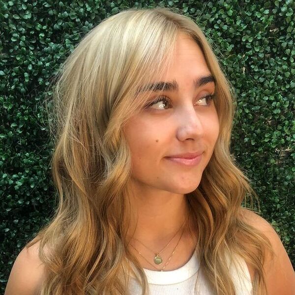 dark blonde hair - a woman wearing a white top