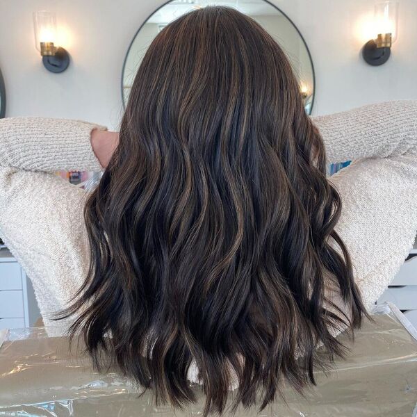 Dark Choco Balayage with Loose Curls - a woman wearing cream sweater.