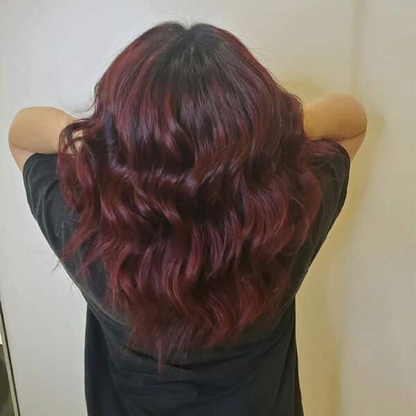 dark red hair - a girl lifting her hair wearing black shirt