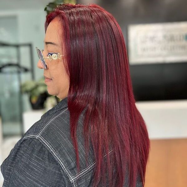 dark red hair - a women wearing glasses and a black denim jacket