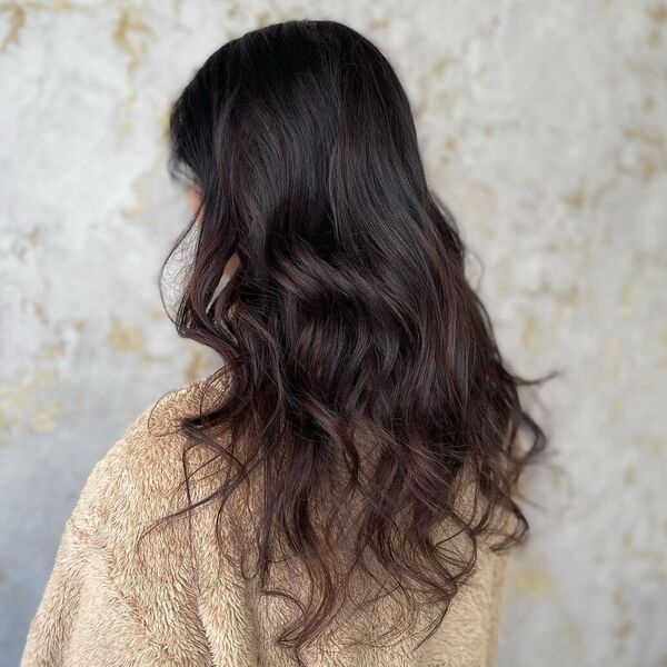 Fine Hickory Balayage on Dark Hair - a woman wearing loose sweater.