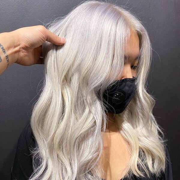 Flowing White Blonde Hair with Waves - a woman wearing a black facemask
