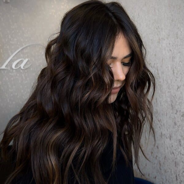 Fudged Beach Waves Balayage - A woman wearing black top.