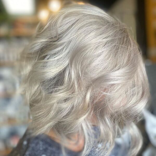 Iced Coconut Platinum Blonde - a woman wearing a glittered blouse