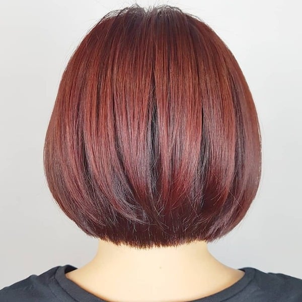 Medium Bob in Vibrant red brown - a woman wearing black shirt.