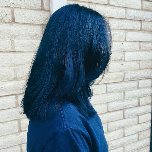Medium Length with Blue Black Hair - a woman wearing a blue shirt