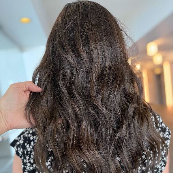 Messy Subtle Brunette Balayage - a woman wearing black floral blouse.