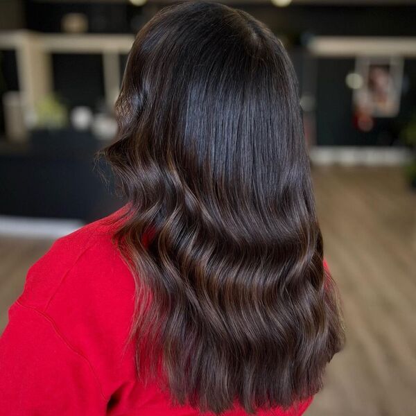 Mid Curles on Balayage - a woman wearing red jacket.