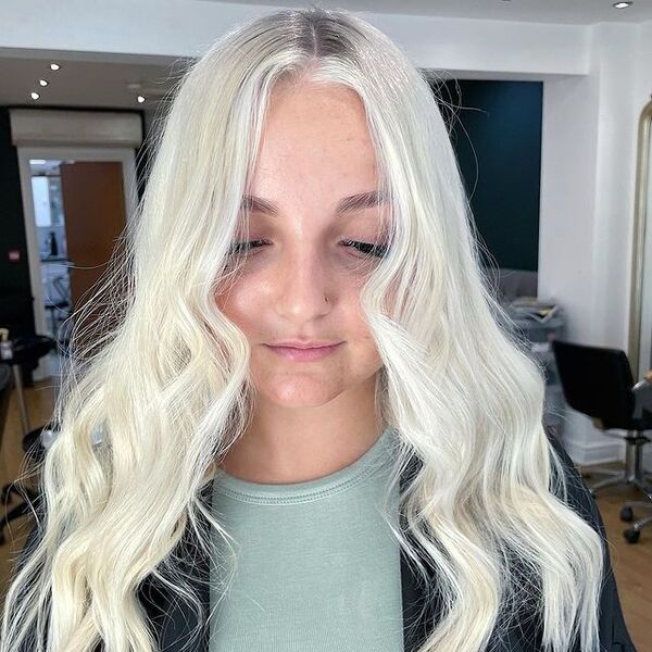Mid-Part Icy White Blonde Hair - a woman inside a salon