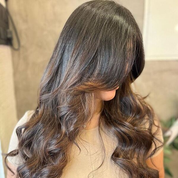 Milk Choco Balayage with Wave Curtain Hairstyle - a woman wearing necklace in beige top.
