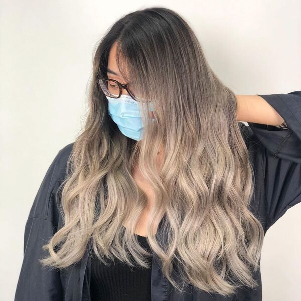 Modern Ash Brown Hair Balayage - a woman wearing a blue facemask and an eyeglasses