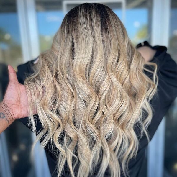 Ombre Orlando Blonde - a woman wearing a black jacket and holding her hair up
