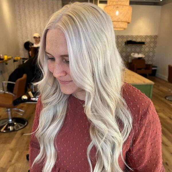 Platinum Blonde for Women Over 30's - a woman in a salon wearing a rust colored blouse